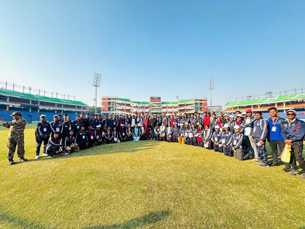 Group of tribal youths exploring Arun Jaitley Stadium with DDCA officials